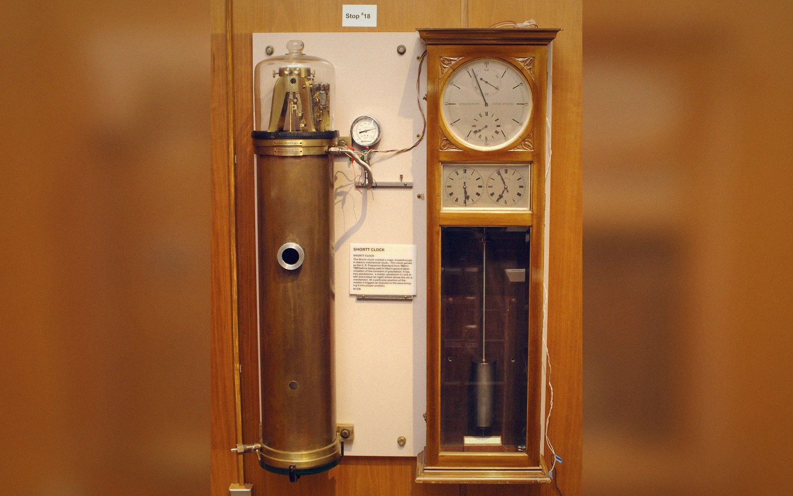 A tall cylindrical vacuum tank containing a pendulum